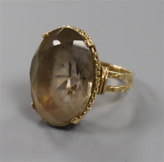 A smoky quartz cocktail ring, yellow gold ropetwist setting and carved shank, size P.